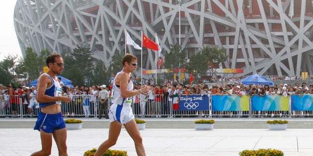 FILE - the Aug. 22, 2008 file photo shows Italy's Alex Schwazer, right, leading Yohan Diniz of France on his way to winning the gold medal in the men's 50-kilometer walk during the athletics competitions near the National Stadium at the Beijing 2008 Olympics in Beijing. Italian Olympic team said Monday, Aug. 6, 2012 that defending 50k walk champion Alex Schwazer tested positive for doping. (AP Photo/Itsuo Inoue)