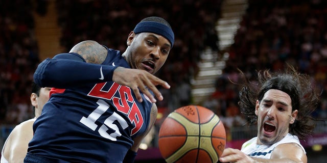 USA's Carmelo Anthony (15) and Argentina's Luis Scola, right, scramble for the ballduring a preliminary men's basketball game at the 2012 Summer Olympics, Monday, Aug. 6, 2012, in London. (AP Photo/Eric Gay)