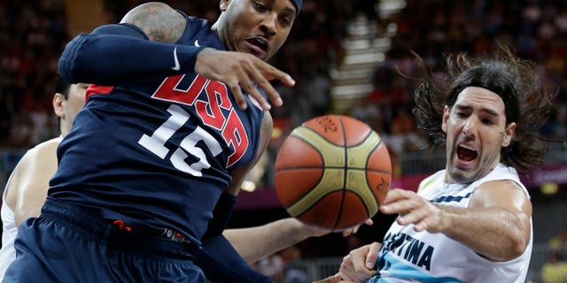 USA's Carmelo Anthony (15) and Argentina's Luis Scola, right, scramble for the ballduring a preliminary men's basketball game at the 2012 Summer Olympics, Monday, Aug. 6, 2012, in London. (AP Photo/Eric Gay)