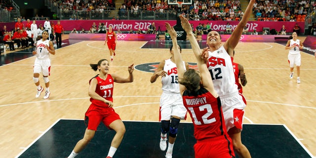 Diana Taurasi (12) of the U.S. shoots over Canada's Lizanne Murphy during a women's quarterfinal basketball match at the 2012 Summer Olympics on Tuesday, Aug. 7, 2012, in London. (AP Photo/Sergio Perez, Pool)