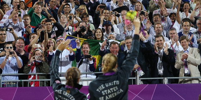 Aug. 8, 2012: Americans Missy May Treanor and Kerri Walsh Jennings acknowledge the crowd with their gold medals in beach volleyball.