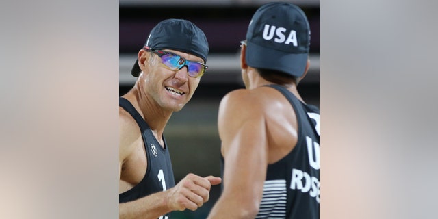 Jake Gibb, left, of US celebrates with his teammate Sean Rosenthal, right, during their Beach Volleyball match against South Africa at the 2012 Summer Olympics, Saturday, July 28, 2012, in London. (AP Photo/Petr David Josek)