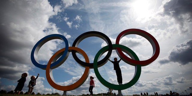 July 30, 2012: Children play on the Olympic rings at the rowing venue.