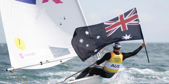 Australia's Tom Slingsby celebrates after winning the gold medal of the laser class sailing competition at the London 2012 Summer Olympics, Monday, Aug. 6, 2012, in Weymouth and Portland, England. (AP Photo/Francois Mori)
