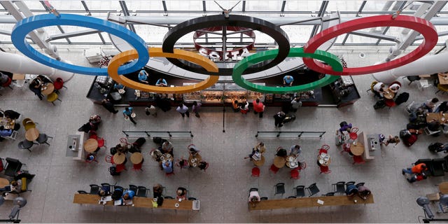 July 17, 2012: Patrons dine below the Olympic Rings at a coffee shot at Heathrow Airport, as London prepares for the 2012 Summer Olympics.