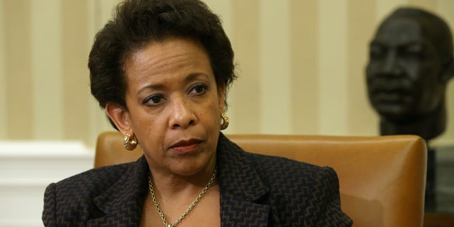 WASHINGTON, DC - MAY 29: U.S. Attorney General Loretta Lynch listens to President Barack Obama as he delivers remarks to reporters after a meeting in the Oval Office at the White House May 29, 2015 in Washington, DC. The first African-American woman to head the Justice Department, Lynch announced this week a major corruption investigation into FIFA, the world's largest soccer organizing body. (Photo by Chip Somodevilla/Getty Images)