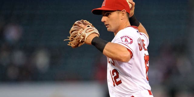 May 7, 2015; Anaheim, CA, USA; Los Angeles Angels second baseman Johnny Giavotella (12) throws to first in the second inning against the Houston Astros at Angel Stadium of Anaheim. Mandatory Credit: Gary A. Vasquez-USA TODAY Sports