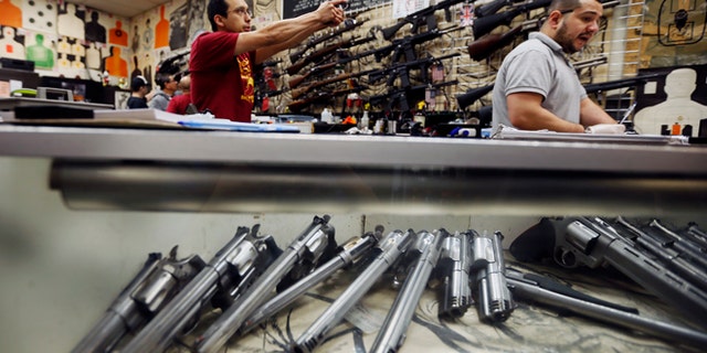 Jan. 23, 2013: Employees demonstrate gun safety to clients at the Los Angeles gun club in Los Angeles.