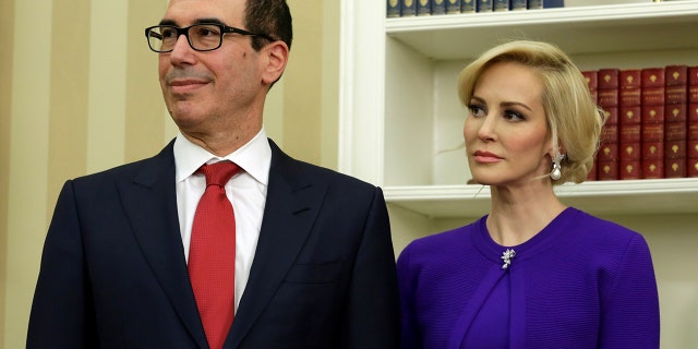 Steve Mnuchin stands with his fiancee Louise Linton before swearing in as Treasury Secretary in the Oval Office of the White House in Washington February 13, 2017.