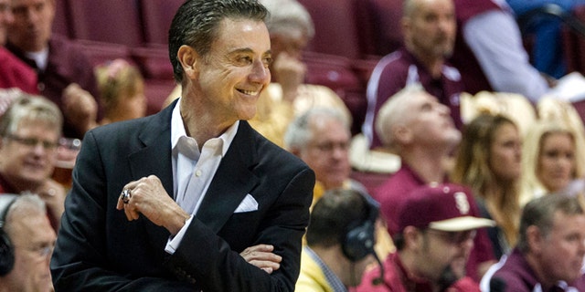 Louisville head coach Rick Pitino smiles at a referee after receiving a warning in the first half of an NCAA college basketball game against Florida State, Saturday, Feb. 28, 2015, in Tallahassee, Fla. (AP Photo/Mark Wallheiser)