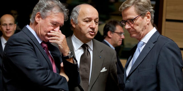 From left, Luxembourg's Foreign Minister Jean Asselborn, French Foreign Minister Laurent Fabius and German Foreign Minister Guido Westerwelle share a word during a meeting of EU Foreign Ministers in Luxembourg on Monday Oct. 15, 2012. Britain, Germany and France say they expect the European Union to approve even tougher sanctions on Iran to prevent it from developing nuclear weapons. (AP Photo/Virginia Mayo)