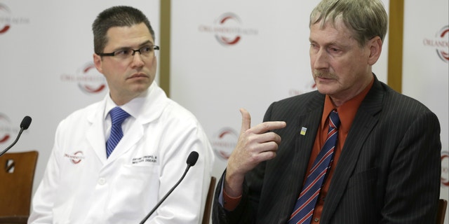 Dr. Kevin Sherin, right, the health officer for the Florida Department of Health in Orange County speaks as Dr. Antonio Crespo, left, the chief quality officer at Dr. P. Phillips Hospital listens, at a news conference to provide an update on the first MERS, or Middle East Respiratory Syndrome case in Florida.