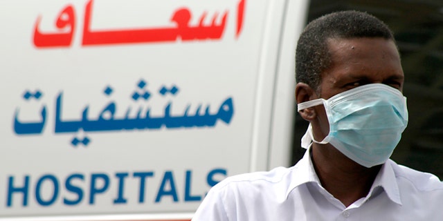 A man, wearing a surgical mask as a precautionary measure against the novel coronavirus, walks near a hospital in Khobar city in Dammam.