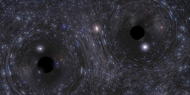 A snapshot of a simulation showing the binary black hole formed in the heart of a dense cluster of stars.