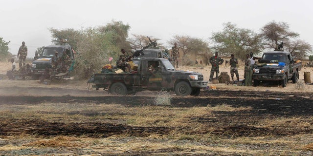 Chadian soldiers drive in the recently retaken town of Damasak, Nigeria, March 18, 2015. Armies from Nigeria, Cameroon, Chad and Niger have launched an offensive to end Boko Haram's six-year campaign, which has killed thousands in northern Nigeria and spilled over into Cameroon and Niger. REUTERS/Emmanuel Braun (NIGERIA - Tags: CIVIL UNREST MILITARY POLITICS) - RTR4TY6I