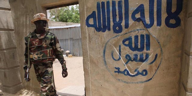 A Nigerien soldier walks out of a house that residents say a Boko Haram militant had forcefully seized and occupied in Damasak March 24, 2015. Boko Haram militants have kidnapped more than 400 women and children from the northern Nigerian town of Damasak that was freed this month by troops from Niger and Chad, residents said on Tuesday. Nigerian, Chadian and Niger forces have driven militants out of a string of towns in simultaneous offensives over the past month. REUTERS/Joe Penney - RTR4UPRZ