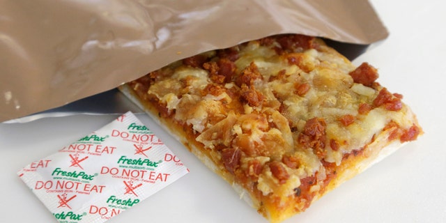 Feb. 6, 2014: A slice of prototype pizza, in development to be used in MRE's -- meals ready to eat -- sits in a packet next to a smaller packet known as an oxygen scavenger, left, at the U.S. Army Natick Soldier Research, Development and Engineering Center in Natick, Mass. Pizza is in development to be used in individual field rations known as meal ready to eat, or MREs. It has been one of the most requested options for soldiers craving a slice of normalcy in the battlefield and disaster areas. (AP/Steven Senne)
