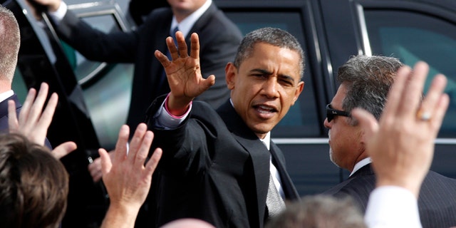 Oct. 23, 2012: President Barack Obama waves to a crowd on the tarmac as he leaves the Dayton International Airport for a campaign event in the Dayton, Ohio.