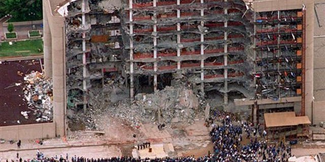 FILE - In this May 5, 1995 file photo, a large group of search and rescue crew attends a memorial service in front of the Alfred P. Murrah Federal Building in Oklahoma City. The blast killed 168 people _ including 19 children _ injured hundreds more and caused hundreds of millions of dollars in damage to structures and vehicles in the downtown area. (AP Photo/Bill Waugh, Flle)