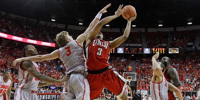 UNLV's Anthony Marshall is fouled by New Mexico's Hugh Greenwood in the second half of a semifinal NCAA college basketball game during the Mountain West Conference tournament, Friday, March 9, 2012, in Las Vegas. (AP Photo/Julie Jacobson)