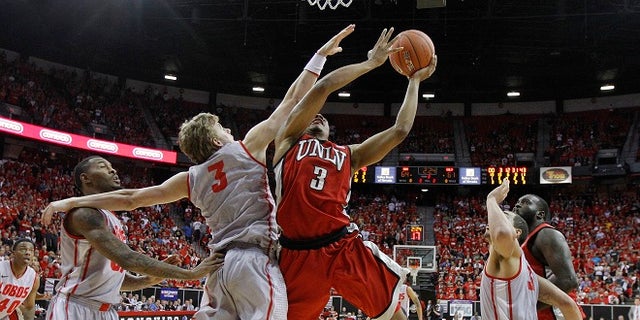 UNLV's Anthony Marshall is fouled by New Mexico's Hugh Greenwood in the second half of a semifinal NCAA college basketball game during the Mountain West Conference tournament, Friday, March 9, 2012, in Las Vegas. (AP Photo/Julie Jacobson)