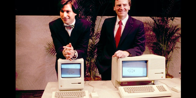 This January 1984 photo shows Apple CEO Steven P. Jobs, left and President John Sculley presenting the new Macintosh Desktop Computer in January 1984 at a shareholder meeting in Cupertino, Calif. January 24, 2014, marks thirty years after the first Mac computer was introduced.