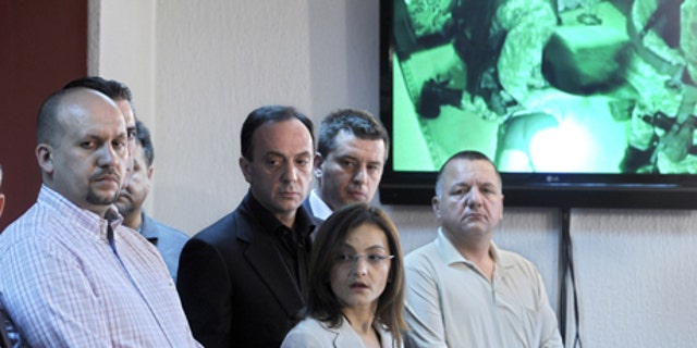 May 1, 2012: Macedonian Interior Minister Gordana Jankuloska, center front, talks to the media surrounded by her associates during a news conference in the capital Skopje. Macedonian authorities say they have arrested 20 people, all radical Islamists, in the murder of five Macedonian fishermen last month that fueled ethnic tensions in this tiny Balkan country. They have been charged with terrorism. (AP)