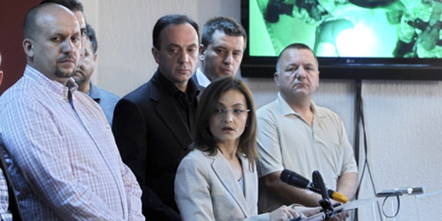 May 1, 2012: Macedonian Interior Minister Gordana Jankuloska, center front, talks to the media surrounded by her associates during a news conference in the capital Skopje. Macedonian authorities say they have arrested 20 people, all radical Islamists, in the murder of five Macedonian fishermen last month that fueled ethnic tensions in this tiny Balkan country. They have been charged with terrorism. (AP)