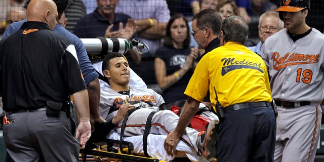 Baltimore Orioles' Manny Machado is taken off the field on a stretcher after injuring his left leg while running to first base on a seventh-inning single off Tampa Bay Rays relief pitcher Jake McGee during a baseball game Monday, Sept. 23, 2013, in St. Petersburg, Fla. (AP Photo/Chris O'Meara)