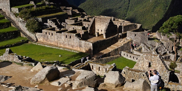 A visitor takes photos at the Inca citadel of Machu Picchu.