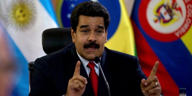 Venezuela's President Nicolas Maduro speaks at a meeting with a South American delegation of foreign ministers at the Miraflores Presidential Palace in Caracas, Venezuela, Tuesday, March 25, 2014. The foreign ministers representing the Union of South American Nations or UNASUR arrived Tuesday aimimg to ease political tensions and facilitate dialogue between Venezuela's government and opponents that are urging Maduro's resignation. (AP Photo/Fernando Llano)