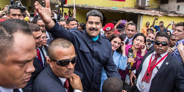 Venezuela's President Nicolas Maduro greets supporters before a ceremony at a monument in  honor of the victims of the 1989 U.S. invasion, in the Chorrillo neighborhood which saw the heaviest fighting during the invasion, in Panama City, Friday, April 10, 2015. A crowd of several hundred chanted in Spanish, "Maduro, stick it to the Yankee!" (AP Photo/Ramon Espinosa)