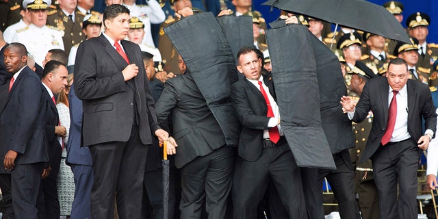 Security personnel surround President Maduro