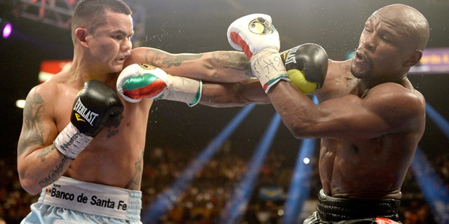 Marcos Maidana and Floyd Mayweather Jr. at the MGM Grand Garden Arena on May 3, 2014 in Las Vegas, Nevada.