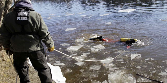 January 11, 2012: A diver maneuvers around sheets of ice as he searches the Kennebec River in Waterville, Maine for 20-month-old Ayla Reynolds who was reported missing since December.
