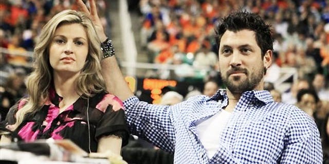 March 13: ESPN broadcaster Erin Andrews, left, is seen with her "DWTS" partner Maksim Chmerkovskiy during the second half of an NCAA college basketball game between Georgia Tech and North Carolina State in Greensboro, N.C.