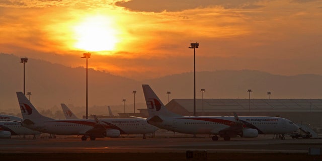 FILE - in this Sunday, Aug. 24, 2014 file photo, Malaysia Airlines planes taxi on the tarmac at Kuala Lumpur International Airport in Sepang, Malaysia. Malaysia Airlines has renamed a promotional competition asking people what activities and destinations are on their 'bucket list' after acknowledging it was inappropriate given the two deadly disasters it has suffered this year. (AP Photo/Lai Seng Sin, File)