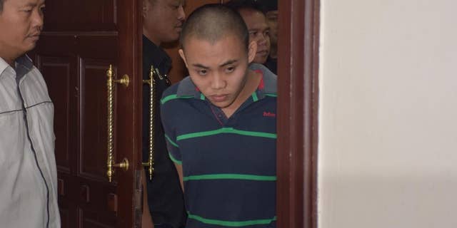 Zulkipli Abdullah, 23, center, walks out from a courtroom in Kuching, Malaysia, on Tuesday, March 31, 2015. On Tuesday, Prosecutor Muhamad Iskandar Ahmad said the high court found Zulkipli guilty of stabbing to death Aidan Brunger and Neil Gareth Dalton, two British medical students, on Borneo island last August. (AP Photo)