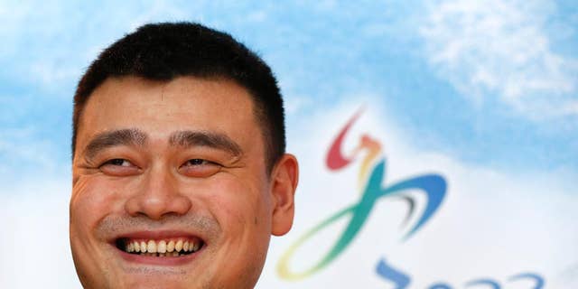 Yao Ming, retired Chinese professional basketball player smiles during a press conference for Beijing 2022 Olympic bid in Kuala Lumpur, Malaysia, Wednesday, July 29, 2015. (AP Photo/Vincent Thian)