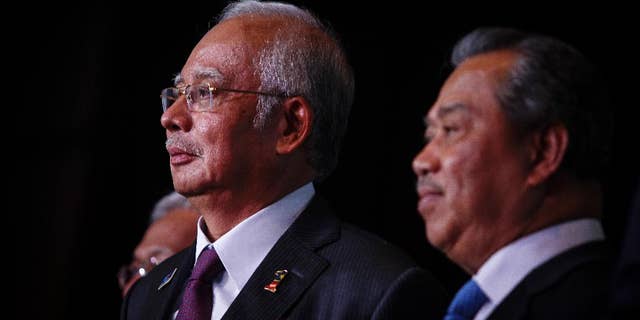 In this April 7, 2015 photo, Malaysian Prime Minister Najib Razak, left, and Deputy Prime Minister Muhyiddin Yassin attends the launch of the Malaysian Education Blue Print at a hotel in Kuala Lumpur, Malaysia. In an interview Thursday April 9, 2015, Najib pledged there will be no cover-up in the investigation of a debt-laden state investment fund and reiterated he is not involved in the murder of a Mongolian woman nine years ago. (AP Photo/Joshua Paul)