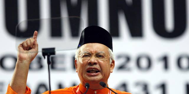 FILE - In this Oct. 21, 2010, file photo, Malaysian Prime Minister Najib Razak gestures as he delivers his opening speech at Malaysia's ruling party United Malays National Organization (UMNO) general assembly in Kuala Lumpur, Malaysia. Razak has a problem: he can't explain away a $700 million bank account to a skeptical public. Less than a month after leaked documents suggested that $700 million from entities linked to debt-ridden state investment fund 1MDB was funneled into Prime Minister Najib Razak’s accounts, he has expelled critics in his government, sacked the attorney-general probing him, suspended two newspapers, blocked a UK-based website and stalled investigations over the scandal. (AP Photo/Lai Seng Sin, File)