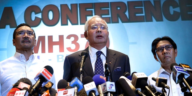 Malaysian Prime Minister Najib Razak, center, Malaysia's Minister for Transport Hishamuddin Hussein, left, and director general of the Malaysian Department of Civil Aviation, Azharuddin Abdul Rahman, delivers a statement to the media regarding the missing Malaysia Airlines jetliner MH370, Saturday, March 15, 2014 in Sepang, Malaysia. Najib said Saturday that investigators believe the missing Malaysian airliner's communications were deliberately disabled, that it turned back from its flight to Beijing and flew for more than seven hours. (AP Photo/Wong Maye-E)