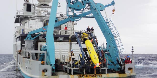 This 2011 photo provided by Sylvain Pascaud shows the ship Alucia and the REMUS 6000 robot sub during the search for Air France Flight 447. Unmanned subs, also called autonomous underwater vehicles or AUVs, played a critical role in locating the wreckage of the lost Air France jet, two years after it crashed in the middle of the south Atlantic. The find allowed searchers to recover the black boxes that revealed the malfunctions behind the tragedy. (AP Photo/Sylvain Pascaud)