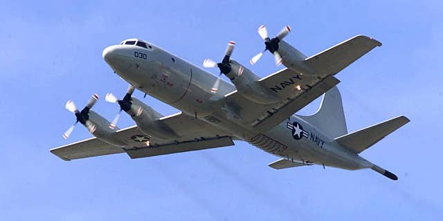 FILE - In this April 4, 2001 file photo, P-3C Orion practices touch-and-go landings at Whidbey Island Naval Air Station near Oak Harbor, Wash. The similar type of the P-3 Orion, favored by the Australian and New Zealand defense forces, is used in the search for the Malaysia Airlines Flight 370 which went missing on March 8, 2014, off the west coast of Australia. Because the search area is so remote, it’s an eight-hour round trip, leaving the planes just two or three hours to search. (AP Photo/Stevan Morgain, File)
