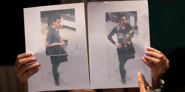Pictures of the two men, a 19-year old Iranian, identified by Malaysian police as Pouria Nour Mohammad Mehrdad, left, and the man on the right, his identity still not released, who boarded the now missing Malaysia Airlines jet MH370 with stolen passports, is held up by a Malaysian policewoman during a press conference, Tuesday, March 11, 2014 in Sepang, Malaysia. One of the two men traveling on a missing Malaysian Airlines jetliner was an Iranian asylum seeker, officials said Tuesday, as baffled authorities expanded their search for the Boeing 777 on the opposite side of the country from where it disappeared nearly four days ago with 239 people on board.(AP Photo/Wong Maye-E)