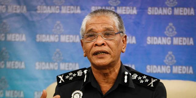 Malaysian police Deputy Inspector Gen. Noor Rashid Ibrahim gestures as he speaks during a press conference at the police headquarters in Kuala Lumpur, Malaysia Wednesday, Sept. 23, 2015. He says eight people, including four believed to be ethnic Uighurs, have been detained in connection with last month's bombing of a shrine in Bangkok that killed 20 people. (AP Photo/Joshua Paul)