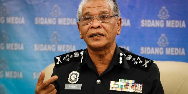 Malaysian police Deputy Inspector Gen. Noor Rashid Ibrahim gestures as he speaks during a press conference at the police headquarters in Kuala Lumpur, Malaysia Wednesday, Sept. 23, 2015. He says eight people, including four believed to be ethnic Uighurs, have been detained in connection with last month's bombing of a shrine in Bangkok that killed 20 people. (AP Photo/Joshua Paul)