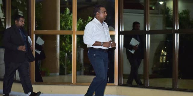 In this Friday, April 10, 2015 photo, Former defense minister Tholath Ibrahim arrives at the Criminal Court in Male, Maldives. The court sentenced Ibrahim to 10 years in prison on charges of detaining a senior judge, the same case in which former president Mohamed Nasheed has also been jailed in a trial widely criticized as politically motivated. (AP Photo/Mohamed Sharuhaan)