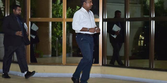 In this Friday, April 10, 2015 photo, Former defense minister Tholath Ibrahim arrives at the Criminal Court in Male, Maldives. The court sentenced Ibrahim to 10 years in prison on charges of detaining a senior judge, the same case in which former president Mohamed Nasheed has also been jailed in a trial widely criticized as politically motivated. (AP Photo/Mohamed Sharuhaan)