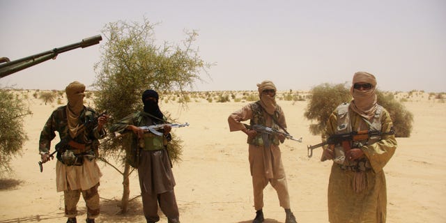 April 24, 2012 - FILE photo: Fighters from Islamist group Ansar Dine stand guard during a hostage handover in the desert outside Timbuktu, Mali.